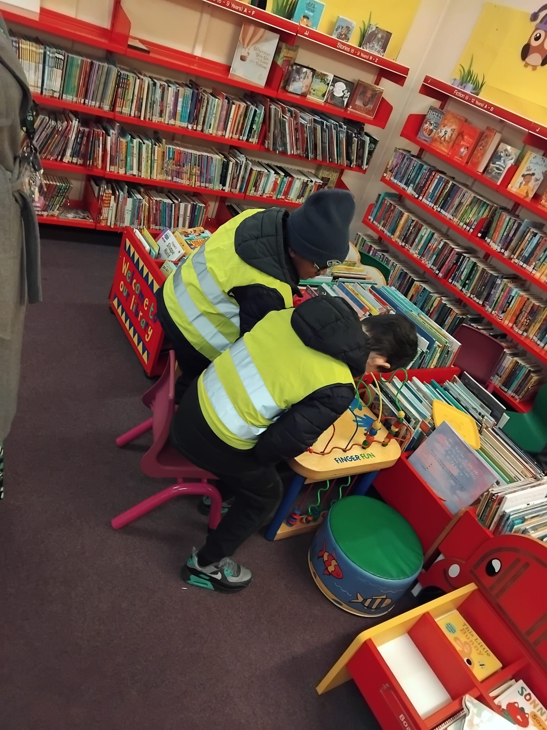 Oak Class exploring books during their library visit near Rowan School.